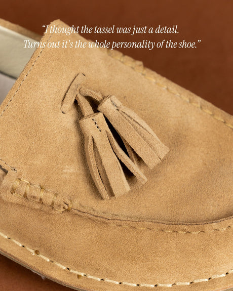 Tan suede desert boot with tassel detail on the vamp and stitched sole.