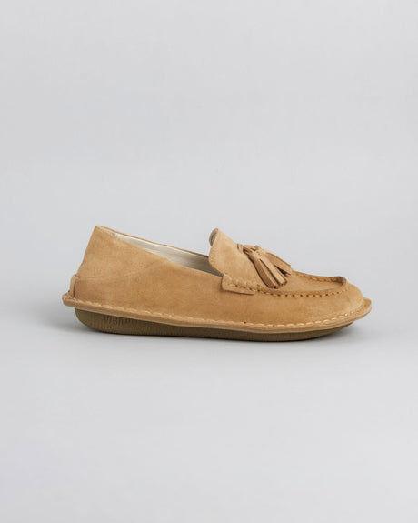Tan suede loafer with tassel detail and crepe sole, shown from the side.